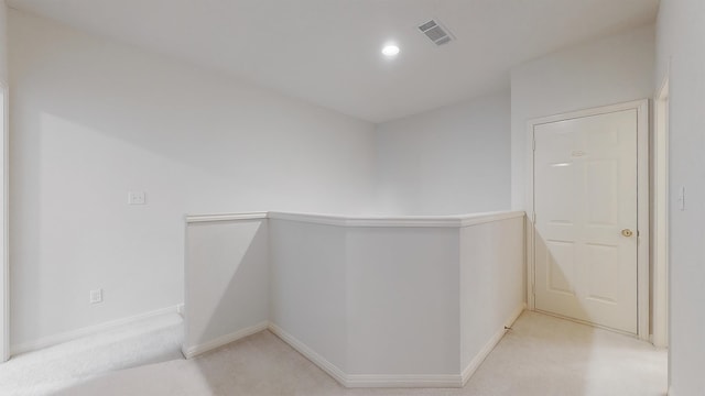 hallway with recessed lighting, light colored carpet, visible vents, an upstairs landing, and baseboards