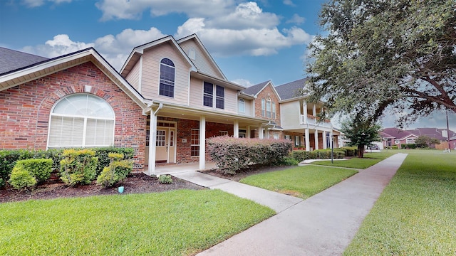 view of front of property featuring brick siding and a front yard