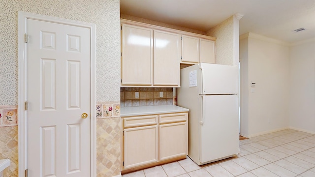 kitchen featuring freestanding refrigerator, light countertops, visible vents, and light tile patterned flooring