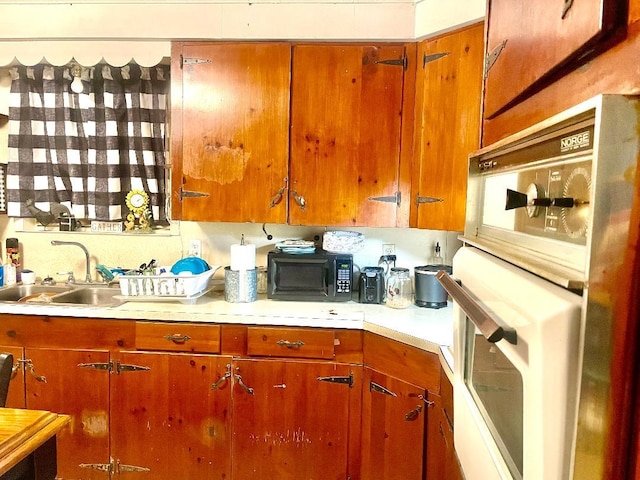 kitchen featuring sink and white oven