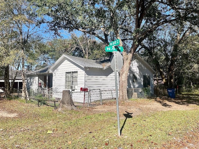 view of side of home with a yard