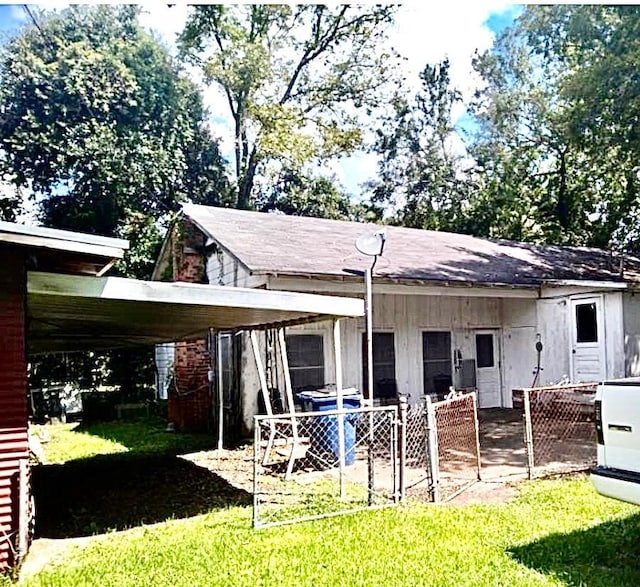 exterior space with a yard and a carport