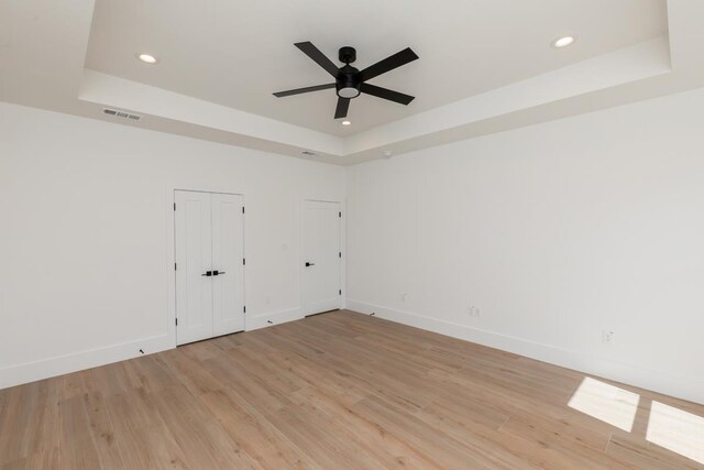 3580 Lily Ln, Beaumont, TX 77713 - unfurnished room featuring a raised ceiling, ceiling fan, light wood-style flooring, and recessed lighting