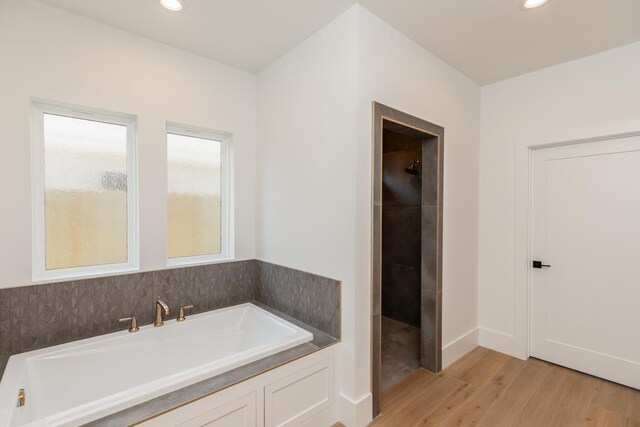 3580 Lily Ln, Beaumont, TX 77713 - bathroom featuring wood finished floors, recessed lighting, and a tile shower