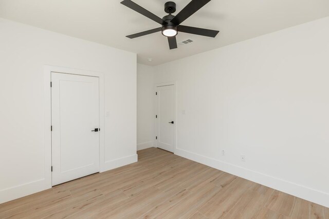 3580 Lily Ln, Beaumont, TX 77713 - unfurnished bedroom with light wood-type flooring, baseboards, and a ceiling fan