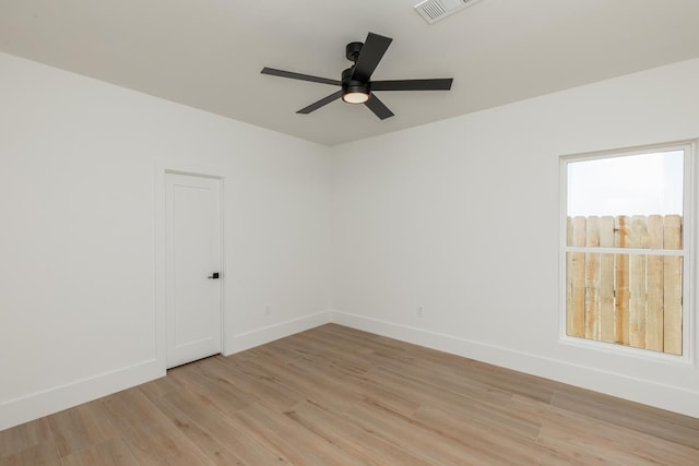 3580 Lily Ln, Beaumont, TX 77713 - empty room with light wood finished floors, a ceiling fan, and baseboards