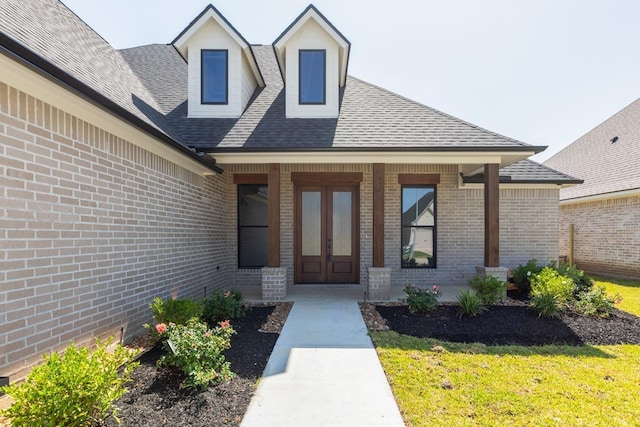 3580 Lily Ln, Beaumont, TX 77713 - doorway to property featuring brick siding, a shingled roof, covered porch, and french doors
