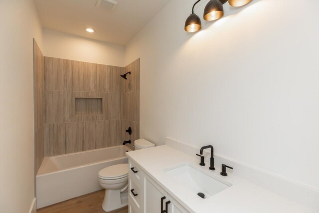 3580 Lily Ln, Beaumont, TX 77713 - bathroom featuring toilet, vanity, washtub / shower combination, wood finished floors, and recessed lighting