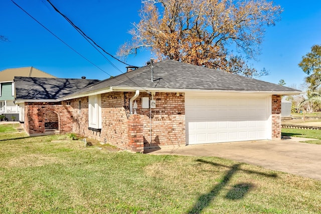 view of front of property with a garage and a front lawn