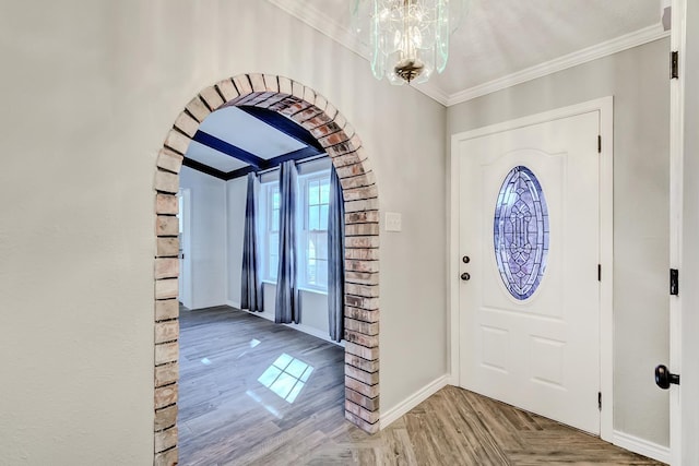 845 Flicker St, Bridge City, TX 77611 - foyer entrance with arched walkways, ornamental molding, a chandelier, and parquet flooring