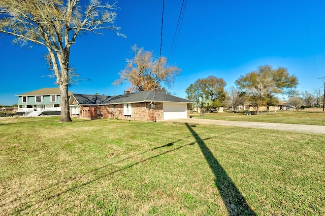 845 Flicker St, Bridge City, TX 77611 - view of front of property with concrete driveway, an attached garage, a front lawn, and brick siding