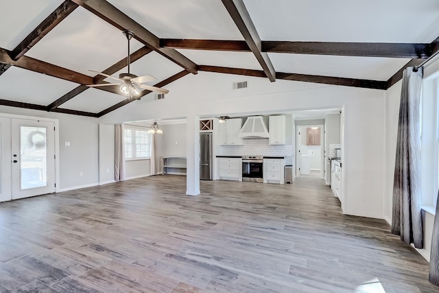 unfurnished living room with lofted ceiling with beams, light hardwood / wood-style floors, and ceiling fan