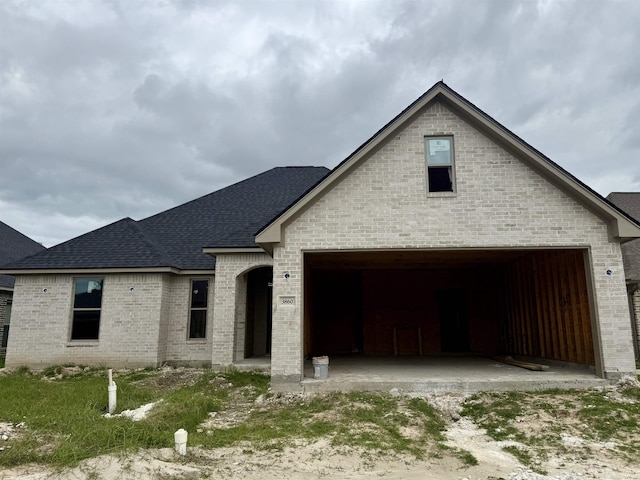 3860 W Pointe Dr, Beaumont, TX 77706 - view of front of home featuring brick siding and a shingled roof