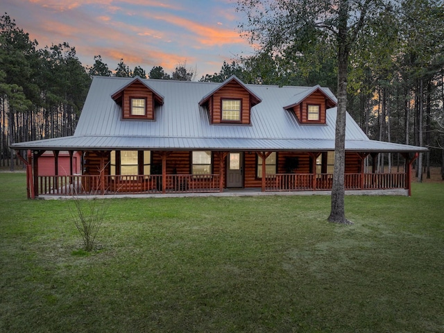 log cabin featuring a yard and covered porch