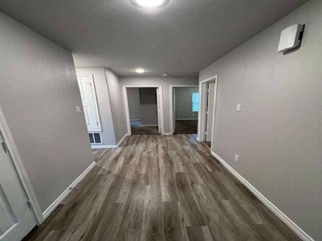 corridor with dark wood-type flooring