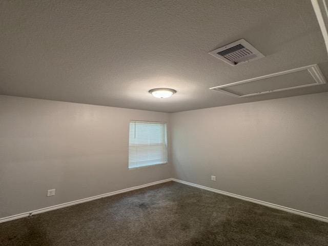 spare room featuring dark carpet