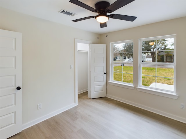 unfurnished bedroom with light wood-type flooring and ceiling fan