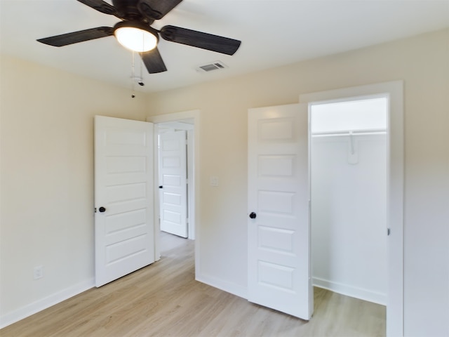 unfurnished bedroom featuring light hardwood / wood-style flooring, ceiling fan, and a closet