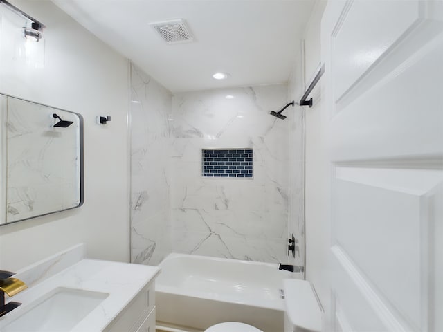 full bathroom with tiled shower / bath combo, vanity, and toilet