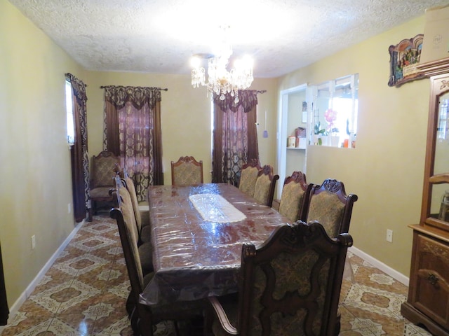 5055 Sunbury Dr, Beaumont, TX 77707 - dining room featuring a textured ceiling, a chandelier, and healthy amount of natural light