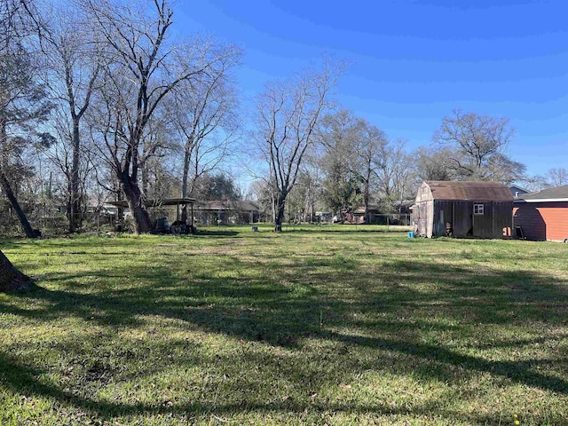 5055 Sunbury Dr, Beaumont, TX 77707 - view of grassy yard featuring a shed