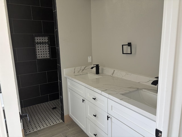 3240 Taft Ave, Groves, TX 77619 - bathroom with wood finish floors, double vanity, a sink, and walk in shower