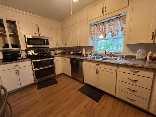 kitchen with sink, white cabinets, and appliances with stainless steel finishes