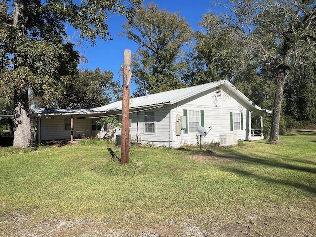 single story home with ac unit and a front lawn