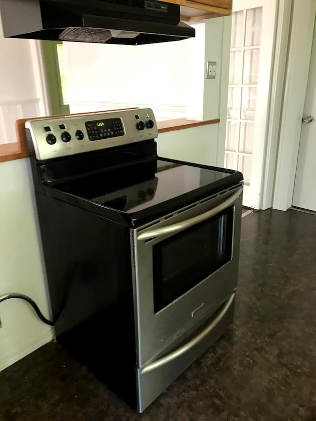 kitchen with ventilation hood and stainless steel electric stove