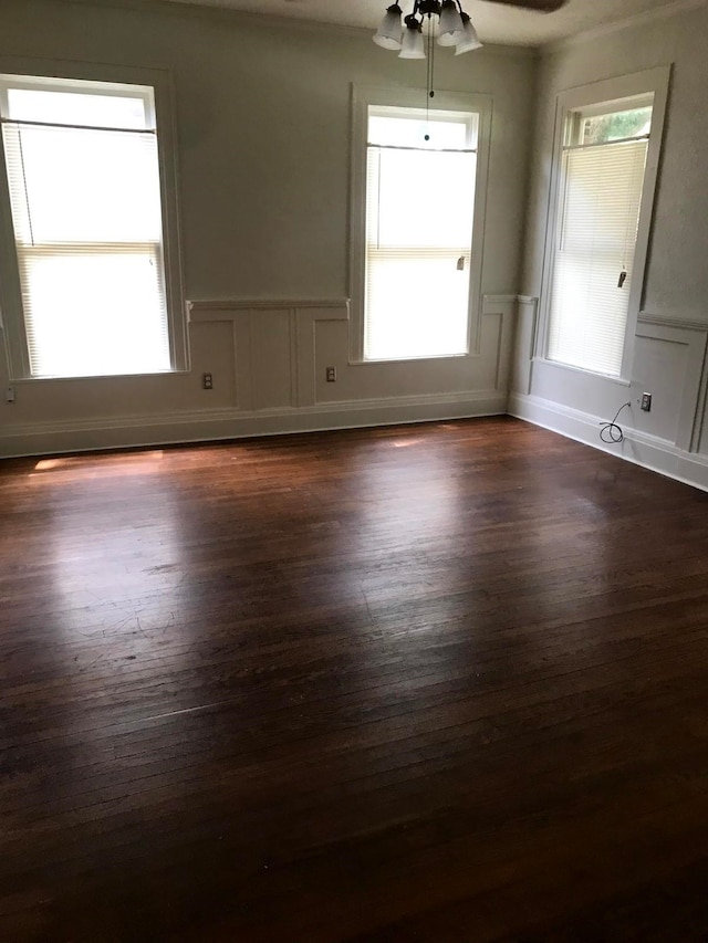 spare room featuring dark hardwood / wood-style floors and ceiling fan