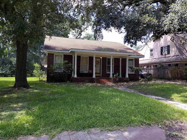 view of front of house with covered porch and a front yard