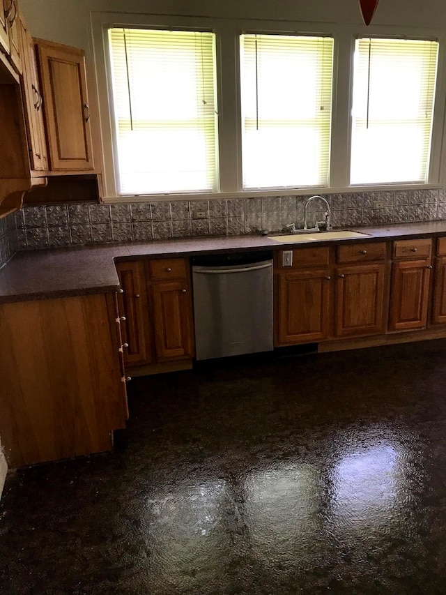 kitchen featuring decorative backsplash, dishwasher, plenty of natural light, and sink