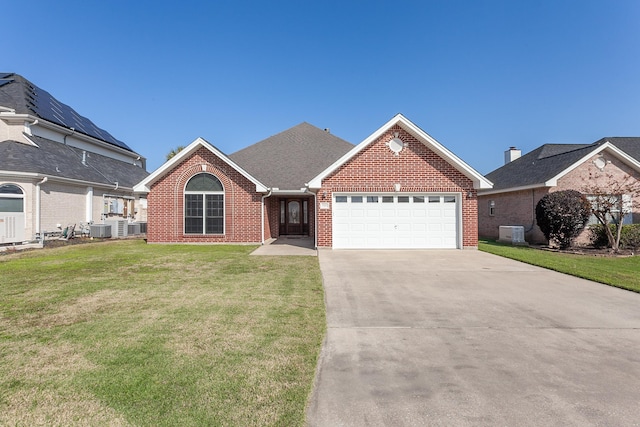 view of front of home featuring a garage, central air condition unit, and a front lawn