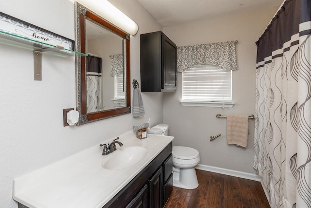 bathroom with vanity, wood-type flooring, and toilet