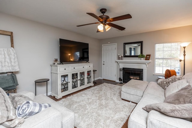 living room featuring hardwood / wood-style flooring and ceiling fan