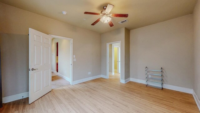 2635 Quiet Corral Ln, Port Arthur, TX 77640 - empty room featuring a ceiling fan, light wood-style flooring, and baseboards