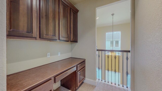 2635 Quiet Corral Ln, Port Arthur, TX 77640 - unfurnished office with built in desk, a textured wall, and baseboards