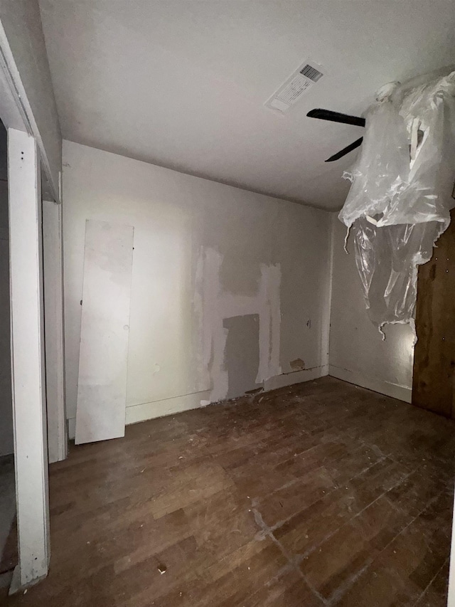 spare room with ceiling fan and dark hardwood / wood-style flooring