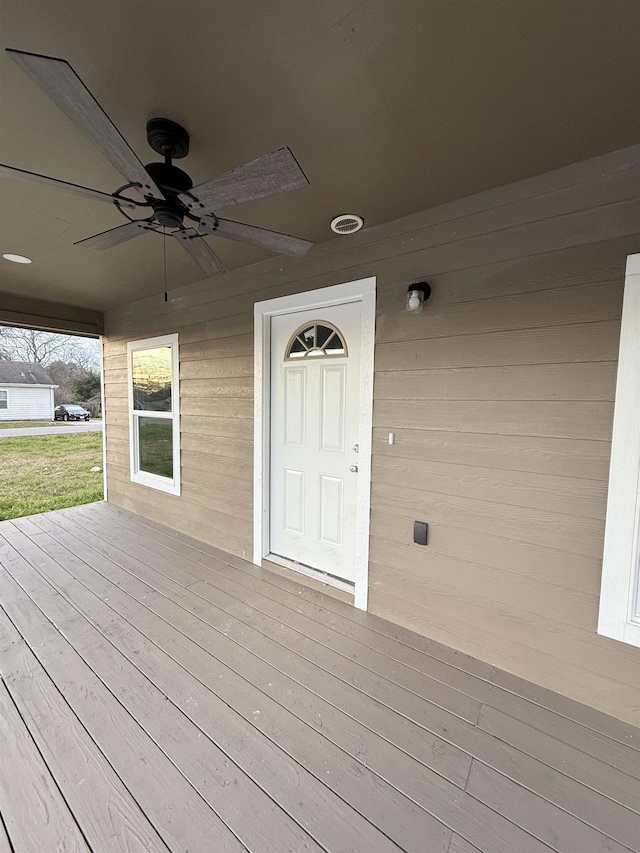 wooden terrace with a ceiling fan