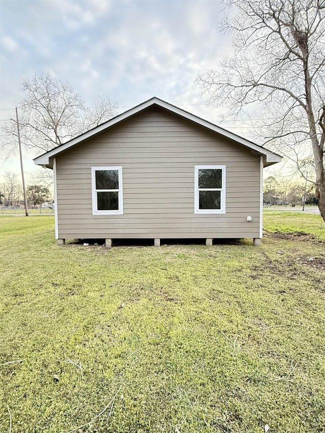 view of side of home featuring a yard