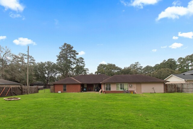 304 Whipoorwill Dr, Silsbee, TX 77656 - rear view of house with an outdoor fire pit