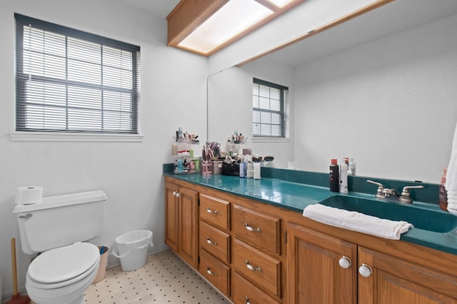 304 Whipoorwill Dr, Silsbee, TX 77656 - bathroom featuring double vanity, toilet, and tile patterned floors