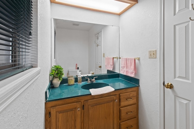 304 Whipoorwill Dr, Silsbee, TX 77656 - bathroom featuring a textured wall and vanity
