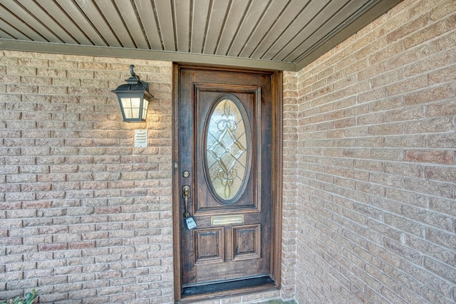 property entrance featuring brick siding