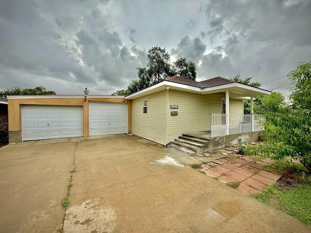 2940 36th St, Port Arthur, TX 77642 - view of front of house with driveway, covered porch, and an attached garage