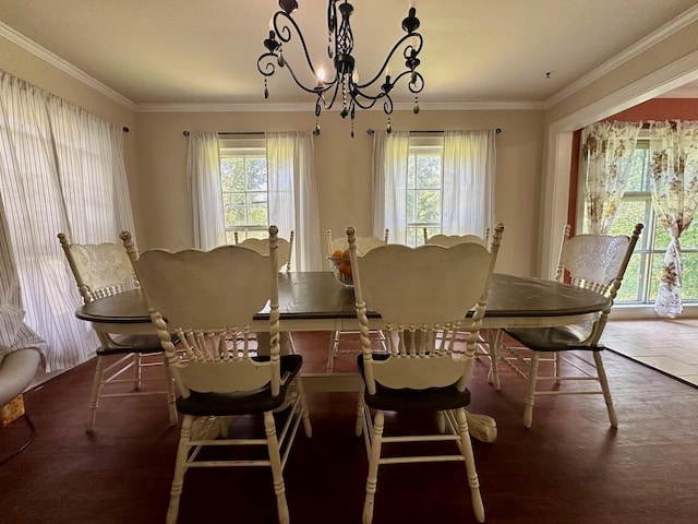 dining area with a healthy amount of sunlight, ornamental molding, and a chandelier