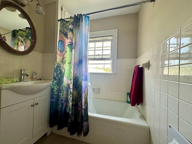 bathroom featuring shower / bath combination with curtain, tile walls, and vanity