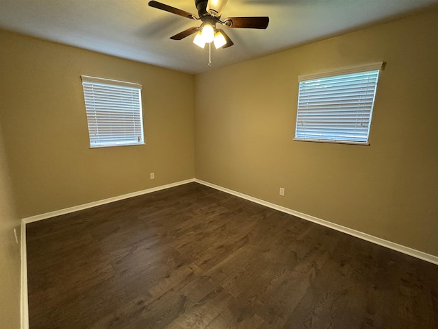 unfurnished room featuring ceiling fan and dark wood-type flooring