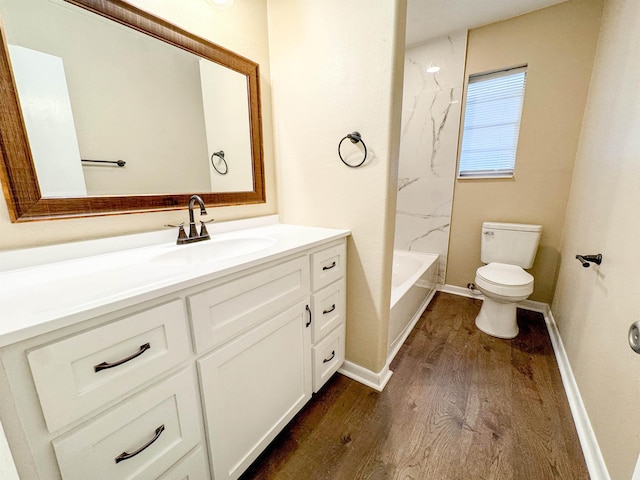 full bathroom featuring hardwood / wood-style floors, vanity, toilet, and tub / shower combination