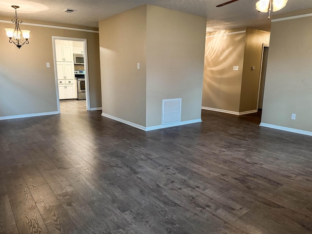 spare room featuring a textured ceiling, crown molding, dark hardwood / wood-style flooring, and ceiling fan with notable chandelier